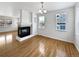 Dining room with hardwood floors and corner fireplace at 9437 E 108Th Dr, Commerce City, CO 80640