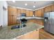 Kitchen with light wood cabinets, granite counters, and island at 9437 E 108Th Dr, Commerce City, CO 80640