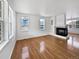Bright living room featuring hardwood floors and a fireplace at 9437 E 108Th Dr, Commerce City, CO 80640
