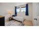 Bedroom with a twin bed, side table, and bright sunlight at 491 Campo St, Denver, CO 80221