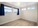Bedroom with large windows providing lots of natural light and hardwood floors at 491 Campo St, Denver, CO 80221