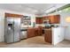 Updated kitchen features stainless steel appliances, granite countertops, track lighting and wood cabinets at 491 Campo St, Denver, CO 80221