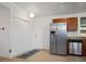 Kitchen features stainless steel refrigerator, granite countertops, white door and modern lighting at 491 Campo St, Denver, CO 80221