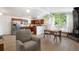 Open floor plan with stainless appliances, wood cabinets, wood floors and a cozy seating area at 491 Campo St, Denver, CO 80221