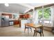 Spacious kitchen with stainless appliances open to the living room with modern lighting and furniture at 491 Campo St, Denver, CO 80221