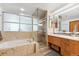 Spa-like bathroom with a soaking tub and glass shower at 1401 Wewatta St # 1006, Denver, CO 80202