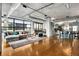 Open living area with modern finishes, city views, and hardwood floors at 1401 Wewatta St # 1006, Denver, CO 80202