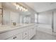 Bathroom with double vanity, large mirror, and a shower/tub combo perfect for relaxing at 16457 Lafayette St, Thornton, CO 80602