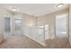 Upstairs hallway featuring carpet, white railing and trim plus lots of natural light from nearby windows at 16457 Lafayette St, Thornton, CO 80602