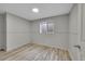 A basement bedroom with hard wood floors, neutral paint, and a window at 2518 S Ouray Way, Aurora, CO 80013