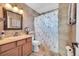 Full bathroom features a vanity with tile countertops, shower, and 'Paris' shower curtain at 2518 S Ouray Way, Aurora, CO 80013