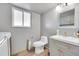 Efficient half bathroom featuring tile floor, a frosted window, and a neutral color scheme at 2518 S Ouray Way, Aurora, CO 80013