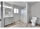 Well-lit bathroom with a shower, toilet, vanity, and a large mirror at 2518 S Ouray Way, Aurora, CO 80013