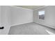 This bedroom boasts natural light with neutral colored walls, gray carpet, and a window at 2518 S Ouray Way, Aurora, CO 80013