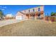 Charming two-story home with mature trees, a porch, and a two car garage at 2518 S Ouray Way, Aurora, CO 80013