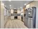 Modern kitchen with stainless steel appliances, mosaic backsplash, and light wood cabinetry at 2518 S Ouray Way, Aurora, CO 80013