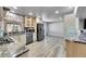 Well-lit kitchen features stainless appliances, granite countertops, and updated cabinets at 2518 S Ouray Way, Aurora, CO 80013