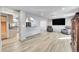 Bright open-plan living room with archway, hardwood flooring, and recessed lighting at 2518 S Ouray Way, Aurora, CO 80013