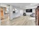 Open-concept living room with hardwood floors, view of kitchen, and plenty of natural light at 2518 S Ouray Way, Aurora, CO 80013