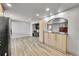 Bright living room with wood-look flooring, recessed lights, and an arched doorway at 2518 S Ouray Way, Aurora, CO 80013