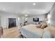 Generous main bedroom with wood-look floors, chandelier, and a large bed with pillows at 2518 S Ouray Way, Aurora, CO 80013