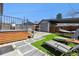 Landscaped backyard featuring artificial turf, stone pavers, and an outdoor seating area at 1308 S Sherman St, Denver, CO 80210