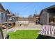 Backyard with a patio, comfortable seating, a grill, and artificial turf at 1308 S Sherman St, Denver, CO 80210