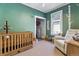 Charming Bedroom with a crib, recliner, and playful decor, creating a warm and inviting space at 1308 S Sherman St, Denver, CO 80210