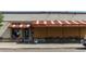 Exterior of The Duffeyroll Café featuring a classic awning, outdoor seating and colorful signage at 1308 S Sherman St, Denver, CO 80210