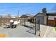 Outdoor deck area with a dining table, chairs, and a fenced yard in the background at 1308 S Sherman St, Denver, CO 80210