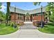 Charming brick building featuring a unique roofline, complemented by mature landscaping and vintage-style street lamps at 1308 S Sherman St, Denver, CO 80210
