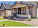 Charming home exterior with a red star, front porch and landscaped yard at 1308 S Sherman St, Denver, CO 80210