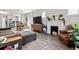 Comfortable living room with fireplace, wood floors, and natural light at 1308 S Sherman St, Denver, CO 80210