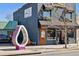 Joe Willy's restaurant exterior with artistic accents and outdoor seating and an art sculpture at 1308 S Sherman St, Denver, CO 80210