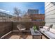 Private balcony with cozy seating area and views of the neighborhood skyline at 3100 Huron St # 2D, Denver, CO 80202