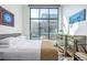 Bright bedroom with large windows, hardwood floors, and a mirrored vanity at 3100 Huron St # 2D, Denver, CO 80202