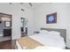 Bedroom featuring a door to a bathroom with a view to the kitchen at 3100 Huron St # 2D, Denver, CO 80202