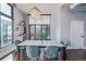 Bright dining room featuring a modern chandelier, seating for six, and access to a private balcony at 3100 Huron St # 2D, Denver, CO 80202