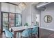 Open concept dining area with modern chandelier, seating for six, and seamless access to the living spaces at 3100 Huron St # 2D, Denver, CO 80202