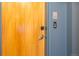 Front door of unit 2D featuring blond wood finish, door knob, and doorbell at 3100 Huron St # 2D, Denver, CO 80202