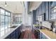 Open kitchen design with a large island, stainless steel appliances, and seamless access to the dining area at 3100 Huron St # 2D, Denver, CO 80202