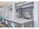 Modern kitchen featuring a large island, stylish gray cabinetry, and stainless steel appliances at 3100 Huron St # 2D, Denver, CO 80202