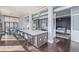 Open concept kitchen with island, breakfast bar and stainless steel appliances and view into bedroom at 3100 Huron St # 2D, Denver, CO 80202