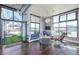 Comfortable living room with large windows, stylish decor, and access to a private outdoor terrace at 3100 Huron St # 2D, Denver, CO 80202