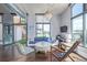 Open-concept living room with modern furnishings, stylish lighting, and access to outdoor terrace at 3100 Huron St # 2D, Denver, CO 80202