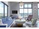 Bright living room featuring hardwood floors, modern furnishings, and large windows for ample natural light at 3100 Huron St # 2D, Denver, CO 80202