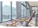 Bright living space with hardwood floors, modern windows and chair at 3100 Huron St # 2D, Denver, CO 80202