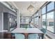 Open floor plan with modern kitchen, dining area and living room, enhanced by a dazzling chandelier at 3100 Huron St # 2D, Denver, CO 80202