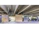 Parking garage featuring two parking spots with storage units, utilities, and concrete construction at 3100 Huron St # 2D, Denver, CO 80202
