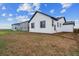 Side view of a white home with a large backyard, ready for your personal touch at 14390 Heritage Dr, Mead, CO 80504